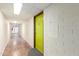 Clean, well-lit hallway leading to apartment B-110, featuring neutral tones and a modern aesthetic at 355 E Thomas Rd # B110, Phoenix, AZ 85012