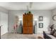 Cozy living room featuring a wooden armoire, neutral tones, and stylish lamps at 355 E Thomas Rd # B110, Phoenix, AZ 85012