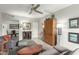 Comfortable living room featuring a gray sofa, ottoman, a ceiling fan, and a wooden cabinet at 355 E Thomas Rd # B110, Phoenix, AZ 85012