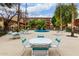Inviting community area with pool, tables, lounge chairs, and well-maintained landscaping and building in the background at 355 E Thomas Rd # B110, Phoenix, AZ 85012