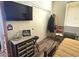 Cozy bedroom offers a warm aesthetic with storage, tv and wooden floors at 35524 N 215Th Dr, Wittmann, AZ 85361