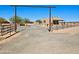 Desert home featuring a gated entrance and drought-resistant landscaping at 35524 N 215Th Dr, Wittmann, AZ 85361