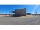 Rear exterior elevation with stone ground covering with parked car under awning at 35524 N 215Th Dr, Wittmann, AZ 85361