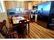 Well-appointed kitchen featuring stainless steel appliances, natural wood cabinets, and a cozy dining area at 35524 N 215Th Dr, Wittmann, AZ 85361