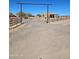 View of the property entrance with a metal gate and desert landscaping at 35524 N 215Th Dr, Wittmann, AZ 85361