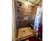 Shower with unique tilework, a convenient shower seat and a fun cowboy-themed curtain at 35524 N 215Th Dr, Wittmann, AZ 85361