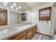 Bright bathroom featuring a large mirror, double sinks, and updated fixtures at 4010 E Grandview St, Mesa, AZ 85205