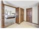 Bedroom entrance featuring wood-framed doorways, neutral tile flooring, and a glimpse into the bedroom at 4010 E Grandview St, Mesa, AZ 85205