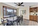 Dining area with a bay window, black table and chairs, plus a decorative rug and built-in cabinets at 4010 E Grandview St, Mesa, AZ 85205