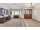 Bright foyer with hardwood front door, carpeted floors, desk, and a bay window showcasing a piano at 4010 E Grandview St, Mesa, AZ 85205