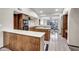 Bright kitchen features wooden cabinets, white countertops, and an island with breakfast bar, plus an adjacent dining area at 4010 E Grandview St, Mesa, AZ 85205