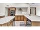 Kitchen featuring wood cabinets, stainless steel appliances, white countertops, an island and a breakfast bar at 4010 E Grandview St, Mesa, AZ 85205