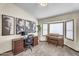 Home office with a desk, computer, piano, and a bay window, perfect for work or creative pursuits at 4010 E Grandview St, Mesa, AZ 85205