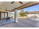 Covered patio featuring an outdoor dining area and views of the backyard and pool at 4010 E Grandview St, Mesa, AZ 85205