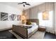Well-lit bedroom with neutral tones, decorative lighting, and a comfortable bed with soft linens at 4219 N 41St Pl, Phoenix, AZ 85018