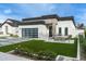 Modern home with a sleek design, well-manicured lawn, and striking stone accents at 4219 N 41St Pl, Phoenix, AZ 85018