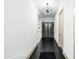 Long hallway with dark floors, white walls, a modern light fixture, and a wine display at 4219 N 41St Pl, Phoenix, AZ 85018