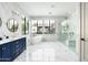 Modern bathroom with a blue vanity, freestanding tub, and luxurious walk-in shower at 4219 N 41St Pl, Phoenix, AZ 85018