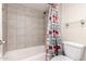 Bathroom with a shower-tub combo and a toilet with colorful shower curtain at 4303 E Cactus Rd # 408, Phoenix, AZ 85032