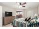Bright bedroom features closet, sliding glass door to patio, ceiling fan, and soft carpeting at 4303 E Cactus Rd # 408, Phoenix, AZ 85032