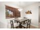 Cozy dining area with a modern table set, complemented by natural light from a nearby window at 4303 E Cactus Rd # 408, Phoenix, AZ 85032