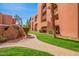 Scenic view of the building exterior with landscaped pathway, palm trees, and well-kept grounds at 4303 E Cactus Rd # 408, Phoenix, AZ 85032