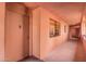 Hallway featuring neutral tones, a window, and access to units, offering a clean and functional space at 4303 E Cactus Rd # 408, Phoenix, AZ 85032