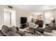Bright living room with tile flooring, comfortable seating, and open access to the dining area at 4303 E Cactus Rd # 408, Phoenix, AZ 85032