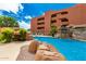 A community pool boasts rock features and landscaping, creating a serene and tropical atmosphere at 4303 E Cactus Rd # 408, Phoenix, AZ 85032