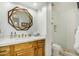 Bathroom with decorative mirror, wood cabinets, and a glass-enclosed shower at 4850 E Desert Cove Ave # 251, Scottsdale, AZ 85254