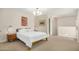 Bedroom with neutral carpet and paint, a wood frame bed, and ample natural light at 4850 E Desert Cove Ave # 251, Scottsdale, AZ 85254