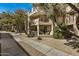 Condo exterior featuring balconies, mature trees, and a pedestrian walkway at 4850 E Desert Cove Ave # 251, Scottsdale, AZ 85254
