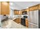Kitchen with stainless steel refrigerator and appliances, granite counters, and light wood cabinets at 4850 E Desert Cove Ave # 251, Scottsdale, AZ 85254