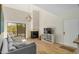 Bright living room with a fireplace, balcony, and wood-look floors at 4850 E Desert Cove Ave # 251, Scottsdale, AZ 85254