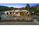 Beautiful aerial view of a home with desert landscaping, outdoor seating, and warm, inviting lighting at 4900 E Arroyo Verde Dr, Paradise Valley, AZ 85253