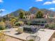 Backyard seating area with modern design, desert landscaping, and mountain views in the background at 4900 E Arroyo Verde Dr, Paradise Valley, AZ 85253