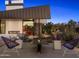Inviting backyard featuring a modern fireplace, desert landscaping, and stylish outdoor furniture at 4900 E Arroyo Verde Dr, Paradise Valley, AZ 85253