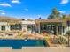 Beautiful backyard with pool, outdoor seating, desert landscaping, and picturesque mountain views at 4900 E Arroyo Verde Dr, Paradise Valley, AZ 85253