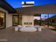 Cozy backyard seating area with fireplace, modern design and desert landscape backdrop at 4900 E Arroyo Verde Dr, Paradise Valley, AZ 85253