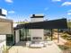 Stunning backyard features modern seating, outdoor fireplace, and landscaping under a blue sky at 4900 E Arroyo Verde Dr, Paradise Valley, AZ 85253