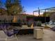 Backyard space featuring a modern fireplace, desert landscaping, and comfortable seating at 4900 E Arroyo Verde Dr, Paradise Valley, AZ 85253