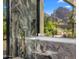 Luxurious marble bath with stylish fixtures, offering stunning mountain views through large windows at 4900 E Arroyo Verde Dr, Paradise Valley, AZ 85253