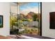 Bedroom with a large window offering stunning views of mountains and desert landscaping, bringing the outdoors inside at 4900 E Arroyo Verde Dr, Paradise Valley, AZ 85253