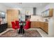 Modern dining area showcases a glass-top table with red chairs and stylish decor at 4900 E Arroyo Verde Dr, Paradise Valley, AZ 85253