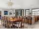 Open-concept dining area with a dining table, modern chandelier and a glass-enclosed wine display at 4900 E Arroyo Verde Dr, Paradise Valley, AZ 85253