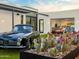 Beautiful exterior view with a classic car, desert landscaping and a modern garage with luxury cars at 4900 E Arroyo Verde Dr, Paradise Valley, AZ 85253