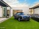 Stunning exterior featuring a classic car on artificial turf and a modern white facade at 4900 E Arroyo Verde Dr, Paradise Valley, AZ 85253