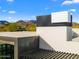 Modern architecture showcasing unique design with dark accents and scenic mountain views in the background at 4900 E Arroyo Verde Dr, Paradise Valley, AZ 85253