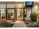 Inviting front entrance featuring modern glass doors, desert landscaping, and bright interiors at 4900 E Arroyo Verde Dr, Paradise Valley, AZ 85253