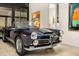 Classic convertible car showcased in a modern garage with contemporary art and ample lighting at 4900 E Arroyo Verde Dr, Paradise Valley, AZ 85253